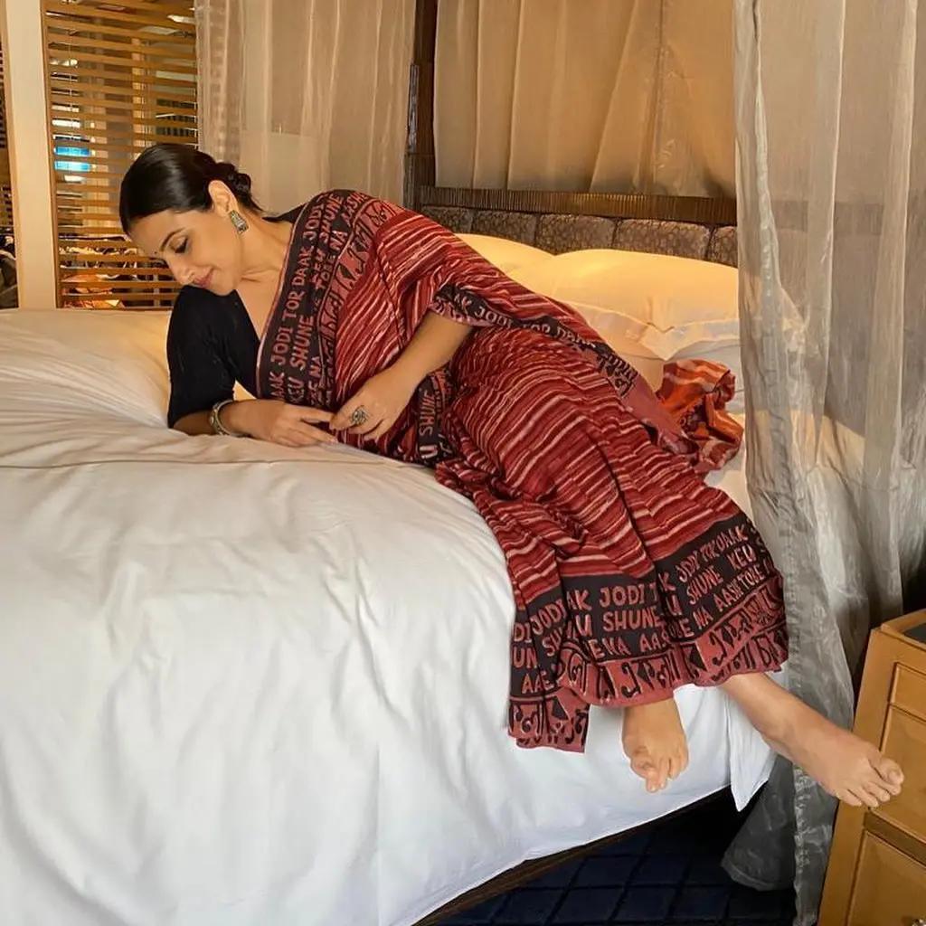 AshtamiVidya Balan looks absolutely amazing in a dark red printed saree paired with a stylish black half-sleeve blouse. Her outfit goes beyond just fashion and makes for a fantastic pick for Ashtami.