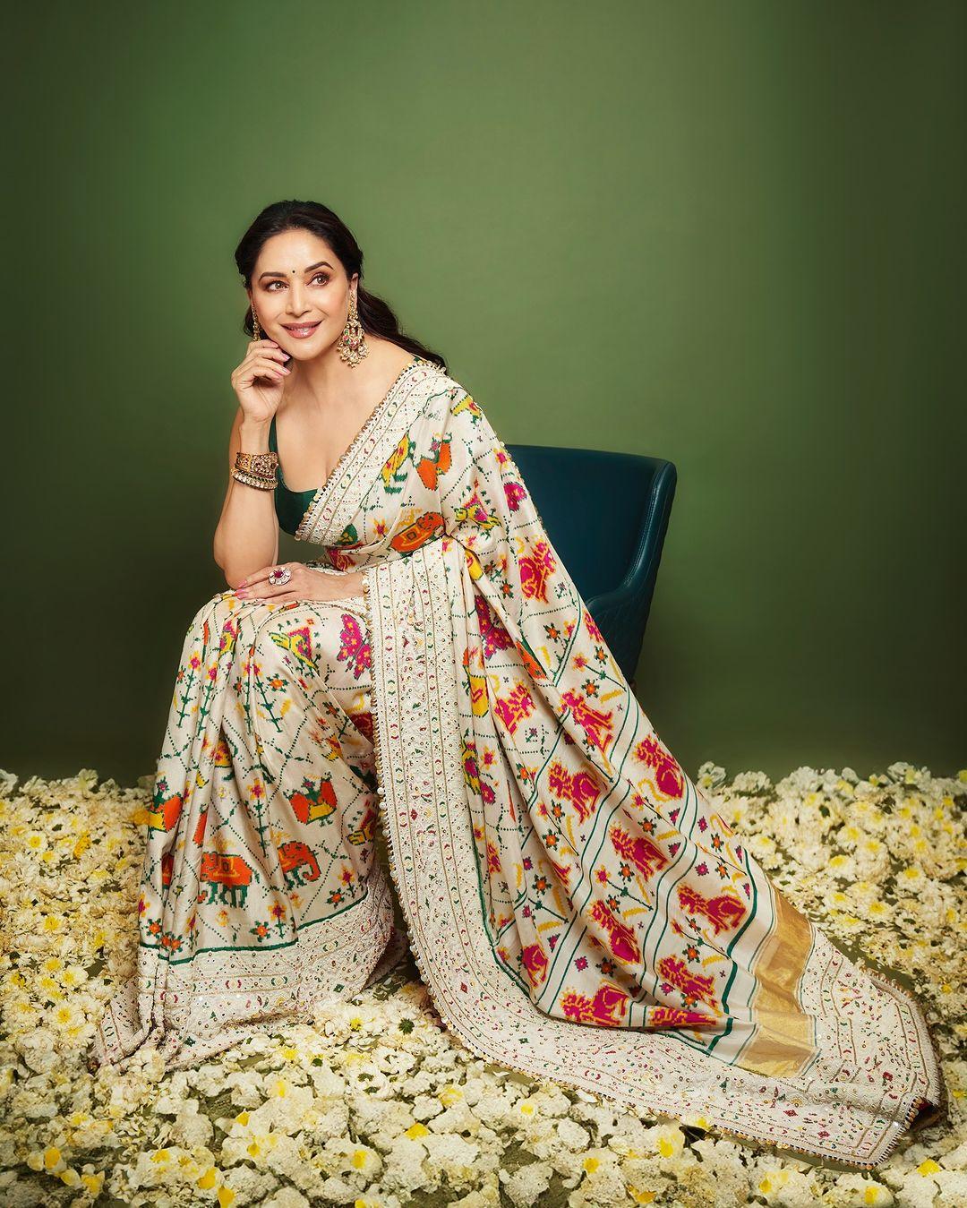 Dressed in a traditional custom patola weave sari finished with intricate pearl work, Madhuri Dixit stole the show at the Ambani's Ganpati celebration