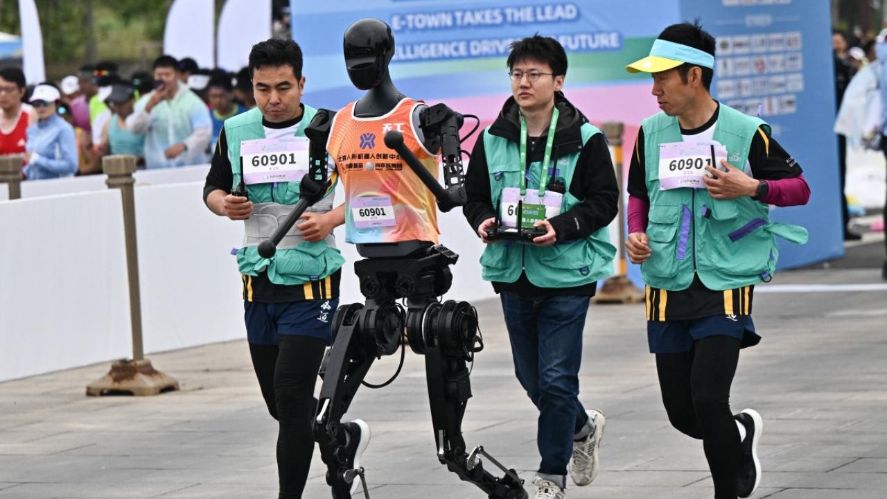 At the crack of the starter's gun, the robots began taking their first tentative steps as the Chinese pop song 