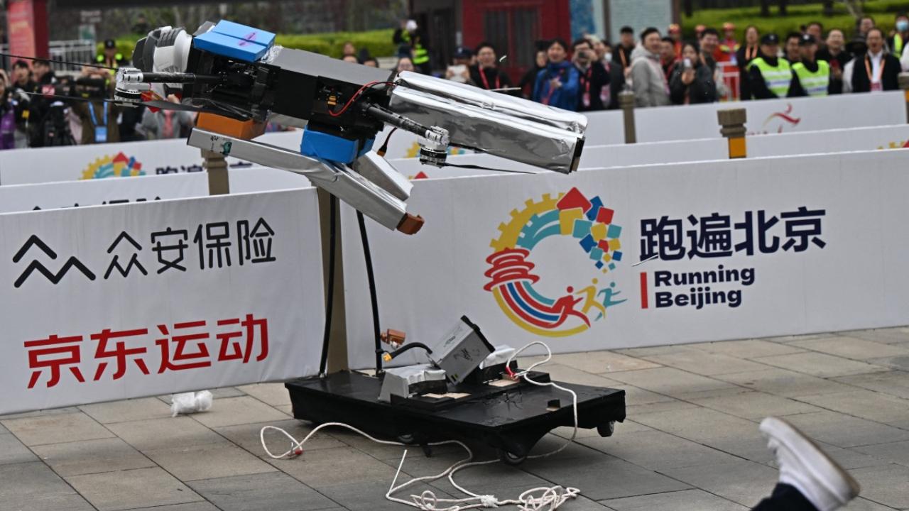 One smaller-sized android fell over and lay on the ground for several minutes, before getting up by itself to loud cheers. Another, powered by propellers, veered across the starting line before crashing into a barrier and knocking over an engineer.