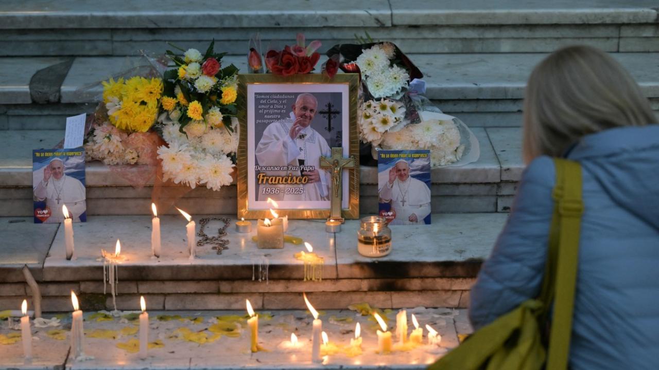 Faithful left lit candles next to a portrait of the late Pope Francis at the entrance of the Buenos Aires Cathedral in Buenos Aires, Argentina