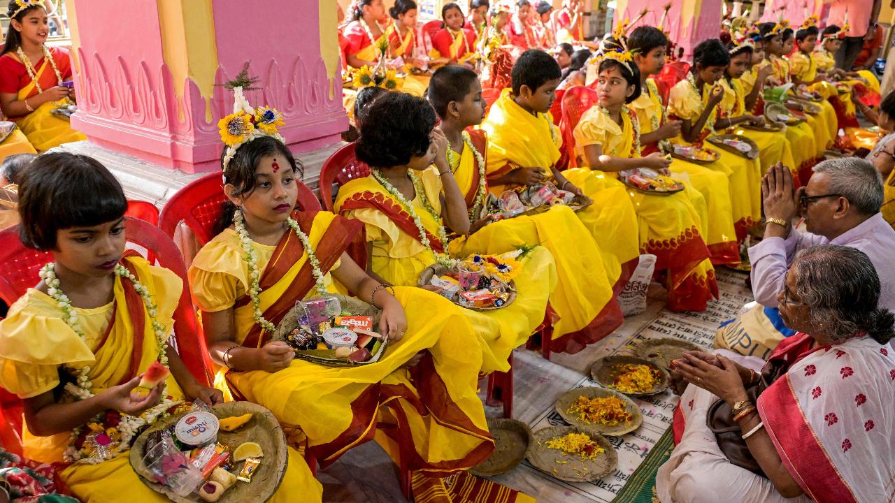 Devotees worship girls dressed in traditional attires as they take part in the 'Kumari Puja' ritual on the outskirts of Kolkata
Kanya Puja, also called Kumari Puja or Kanjak Puja, was also performed on Ram Navami. During this puja, young girls are worshipped as they are believed to embody the nine forms of Goddess Durga.