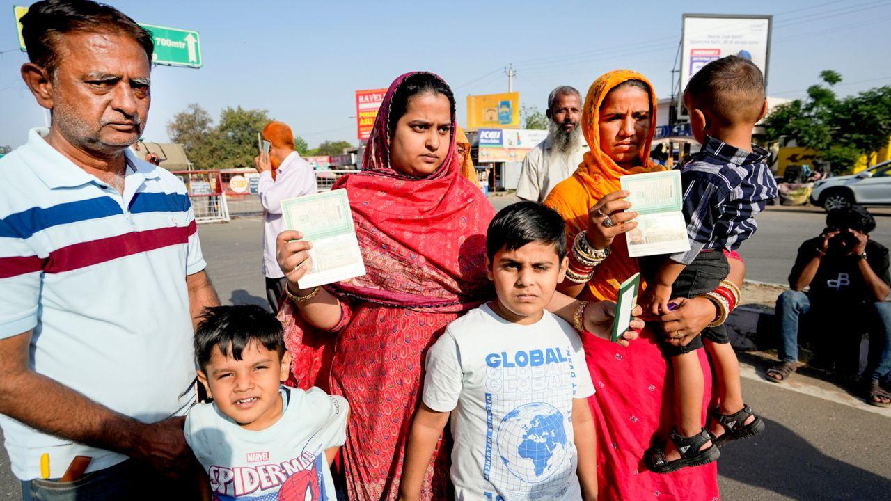 A family with women having Indian passports and others Pakistani passports waits for clearance to cross the border at the Integrated Check Post at Attari-Wagah border, near Amritsar