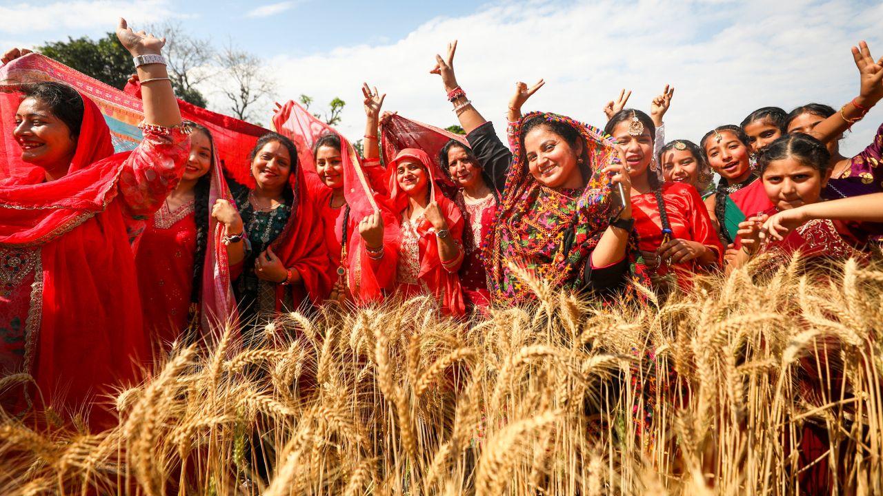 Woman perform the 'bhangra' on the occasion of Baisakhi, in Jammu