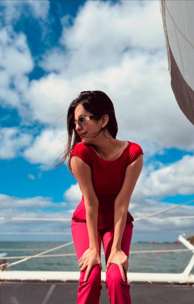 Barkha wore a tangy red top with flared blush pink pants, loose hair, and glossy pink lip gloss—making it a perfect outfit for summer outings