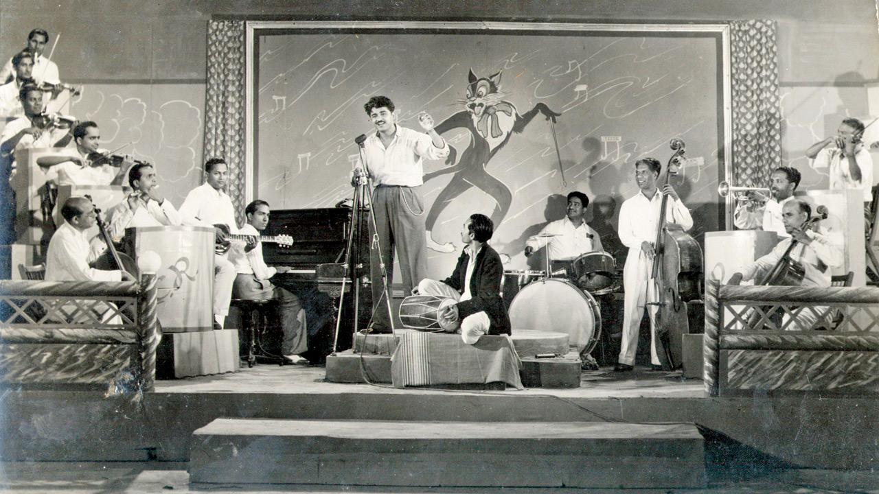 C Ramchandra (standing, centre) on stage 