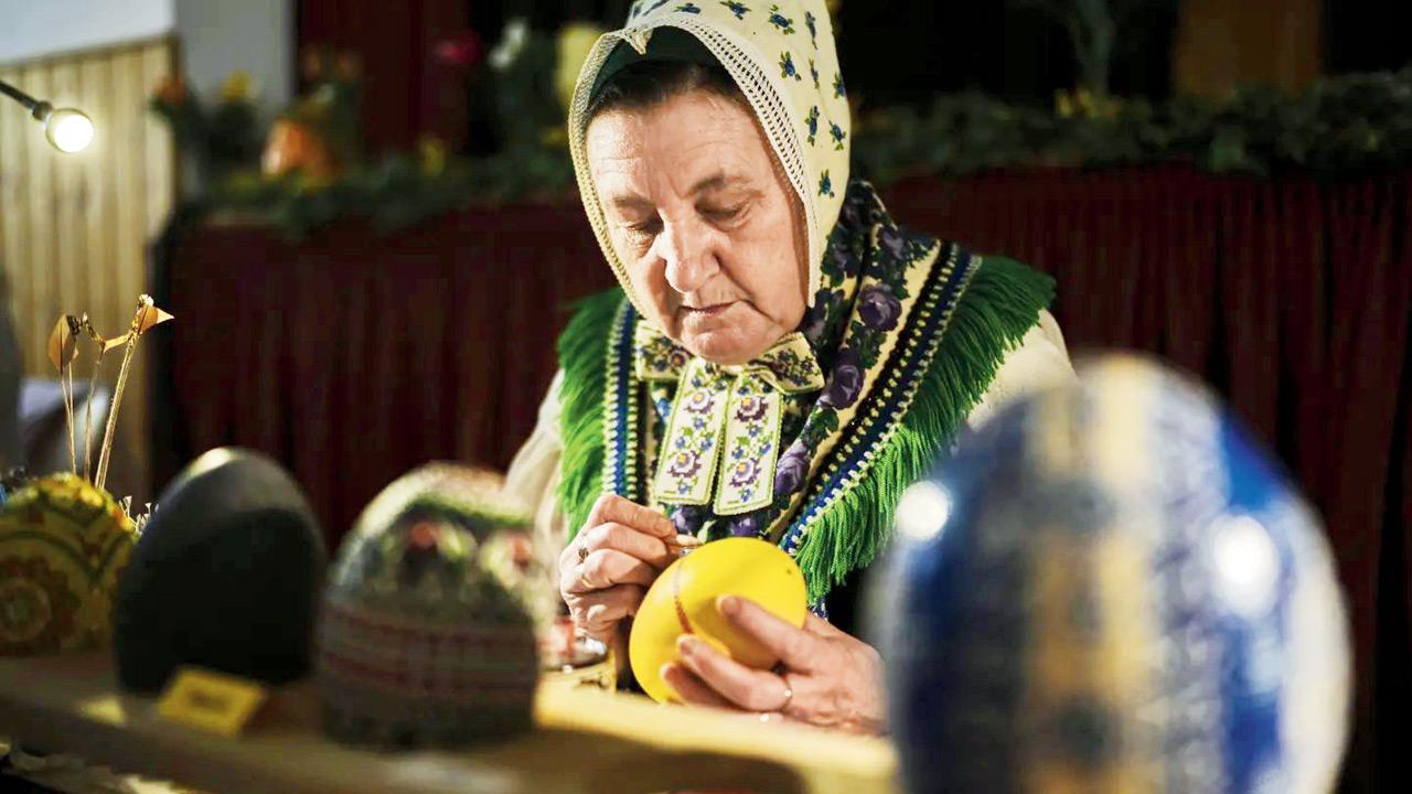 Petra Nakoinz, of Germany’s Slavic-speaking Sorbian ethnic minority, decorates an ostrich egg