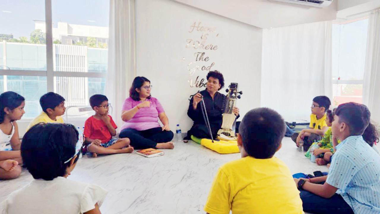 Farooque Latif Khan (centre) shares insights with children during his visit
