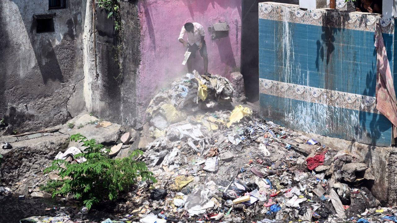 The dumping of waste into the drain raises concerns about clogging, waterlogging, and potential health hazards in the area