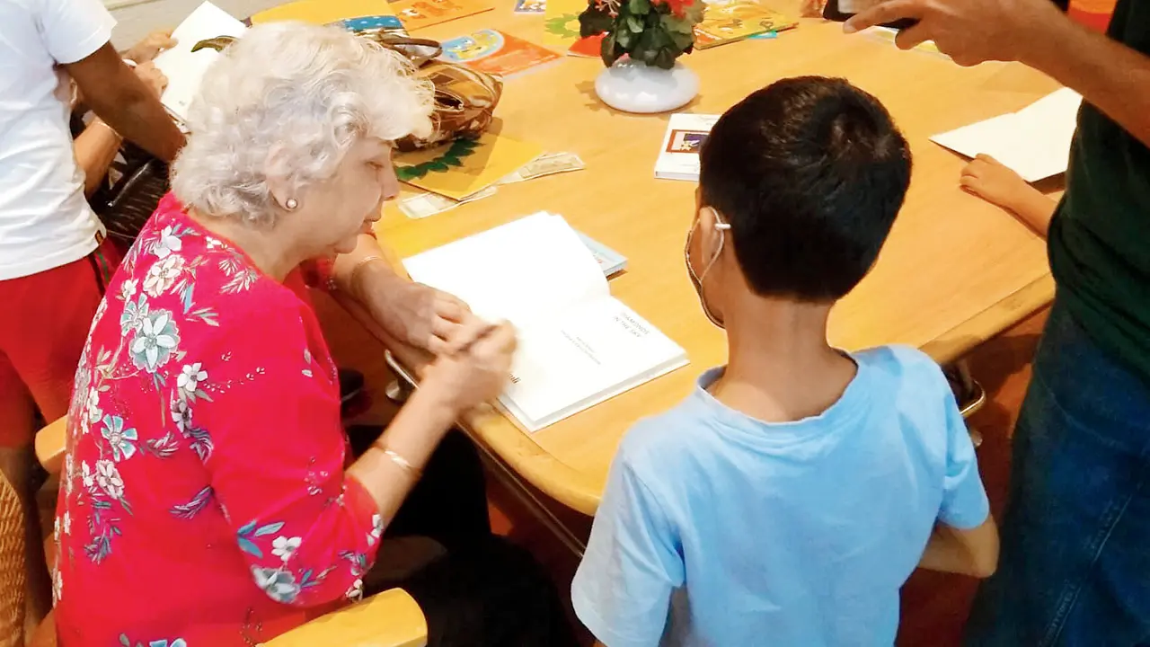 Author Katie Bagli signs an autograph for a young fan. Pics Courtesy/Nehru Centre Library