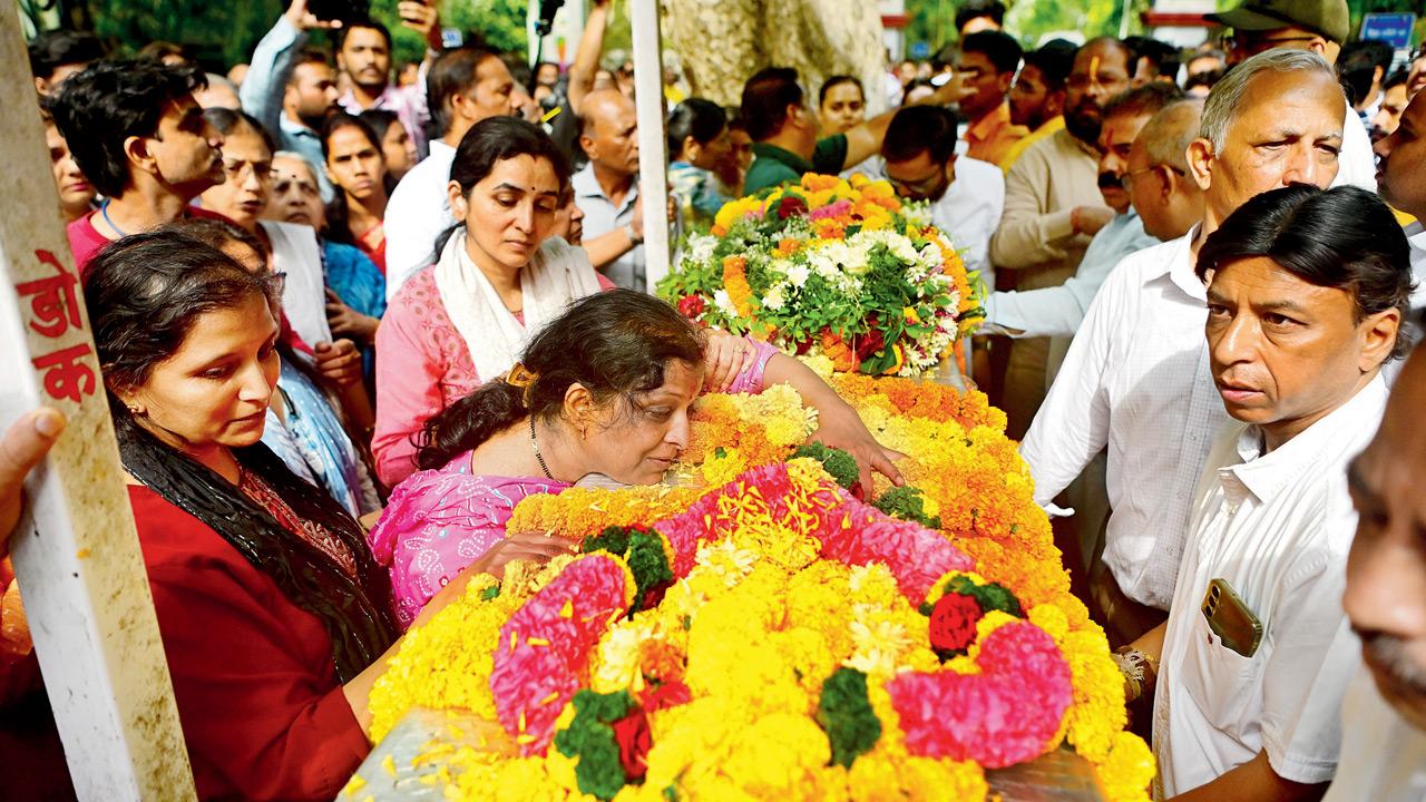 Santosh Jagdale’s wife Pragati clings to her husband’s coffin