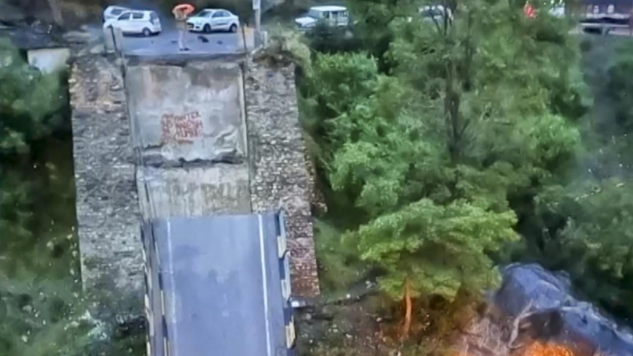 A truck passing over the bridge at the time plunged into the river, leaving the driver with minor injuries, they said