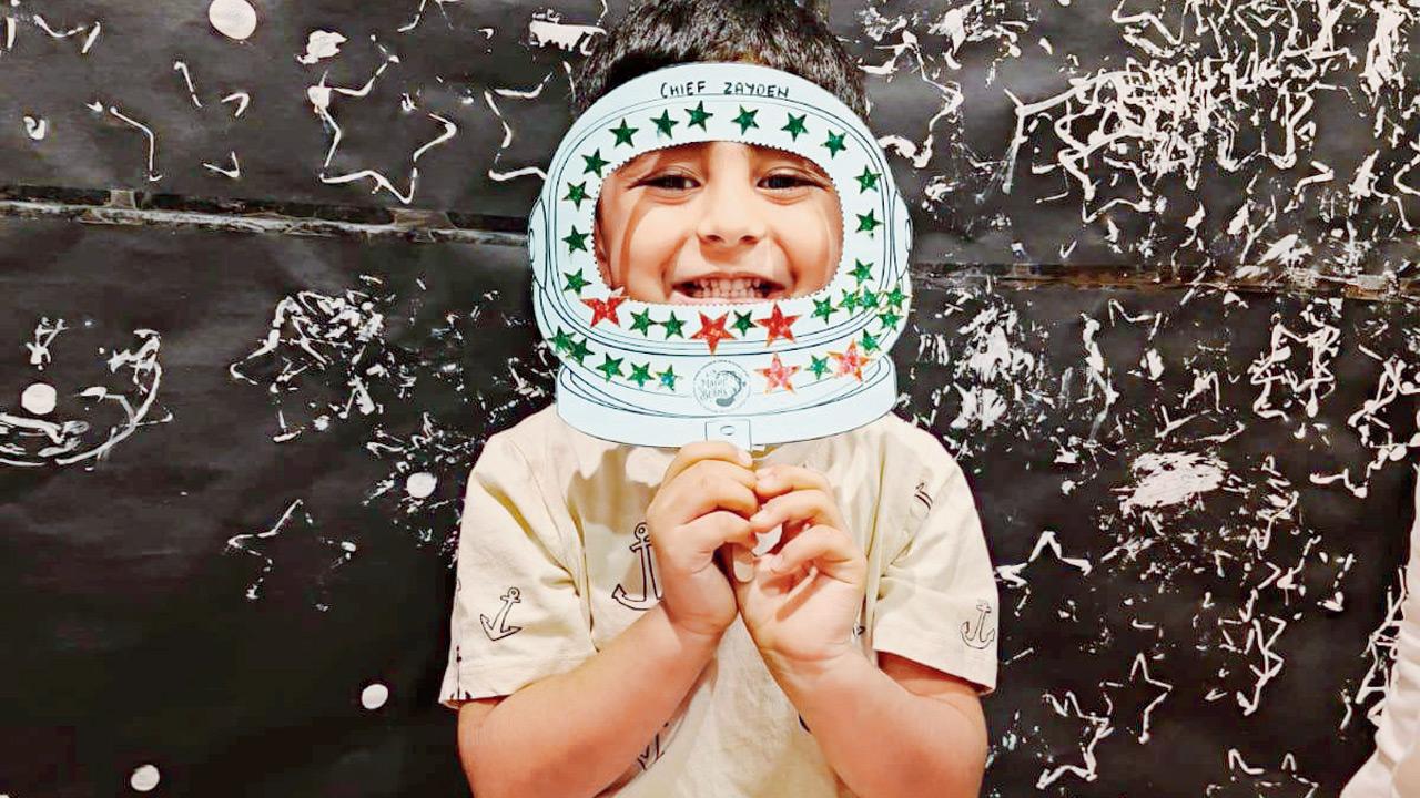 A kid sports a fun placard during an interactive activity. Pic courtesy/Magicbeans