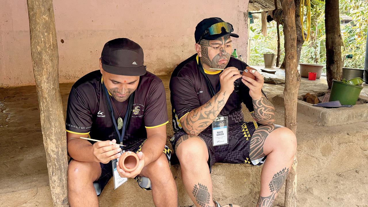 Members of the Maori community attempt Warli painting on earthen cups
