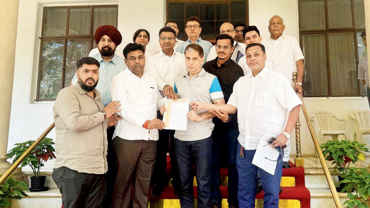 Mumbai Water Tanker Association members give a memorandum containing their demands to civic chief Bhushan Gagrani (with blue sleeves) at his Malabar Hill residence on Monday
