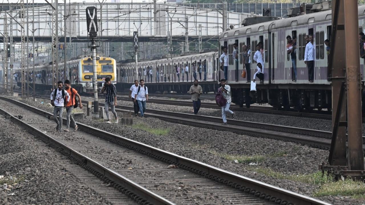 In Photos: Mumbai local train disruption forces commuters onto tracks