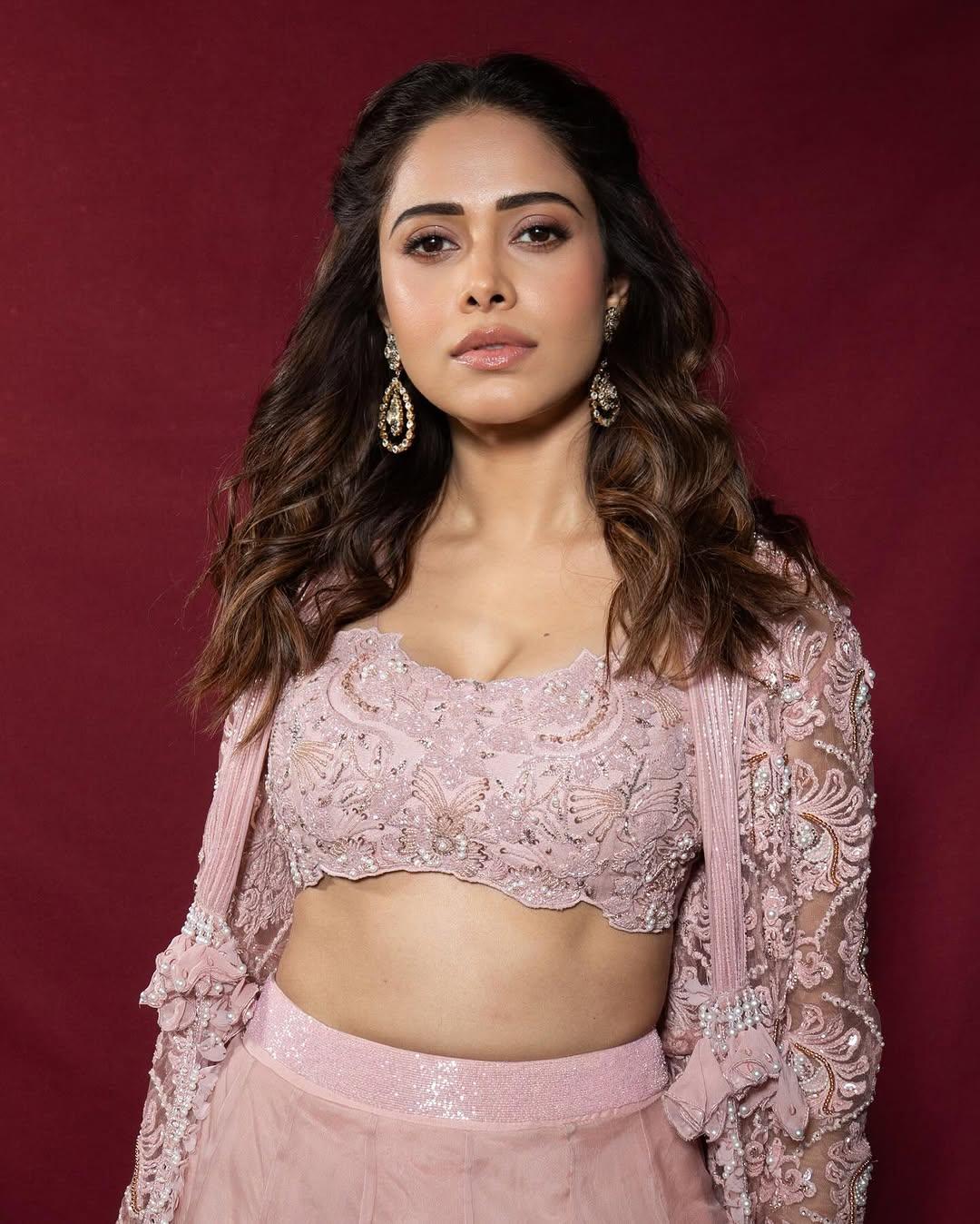 To finish off her appearance, Nushrratt tied her hair in loose curls, wore minimal makeup, and chose big earrings as accessories