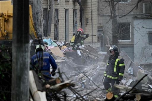 A woman trapped under debris was pulled out alive, moaning in pain and covered in dust, as medics assisted her. In one haunting scene, an elderly woman sat bloodied and dazed against a wall while emergency responders treated her.