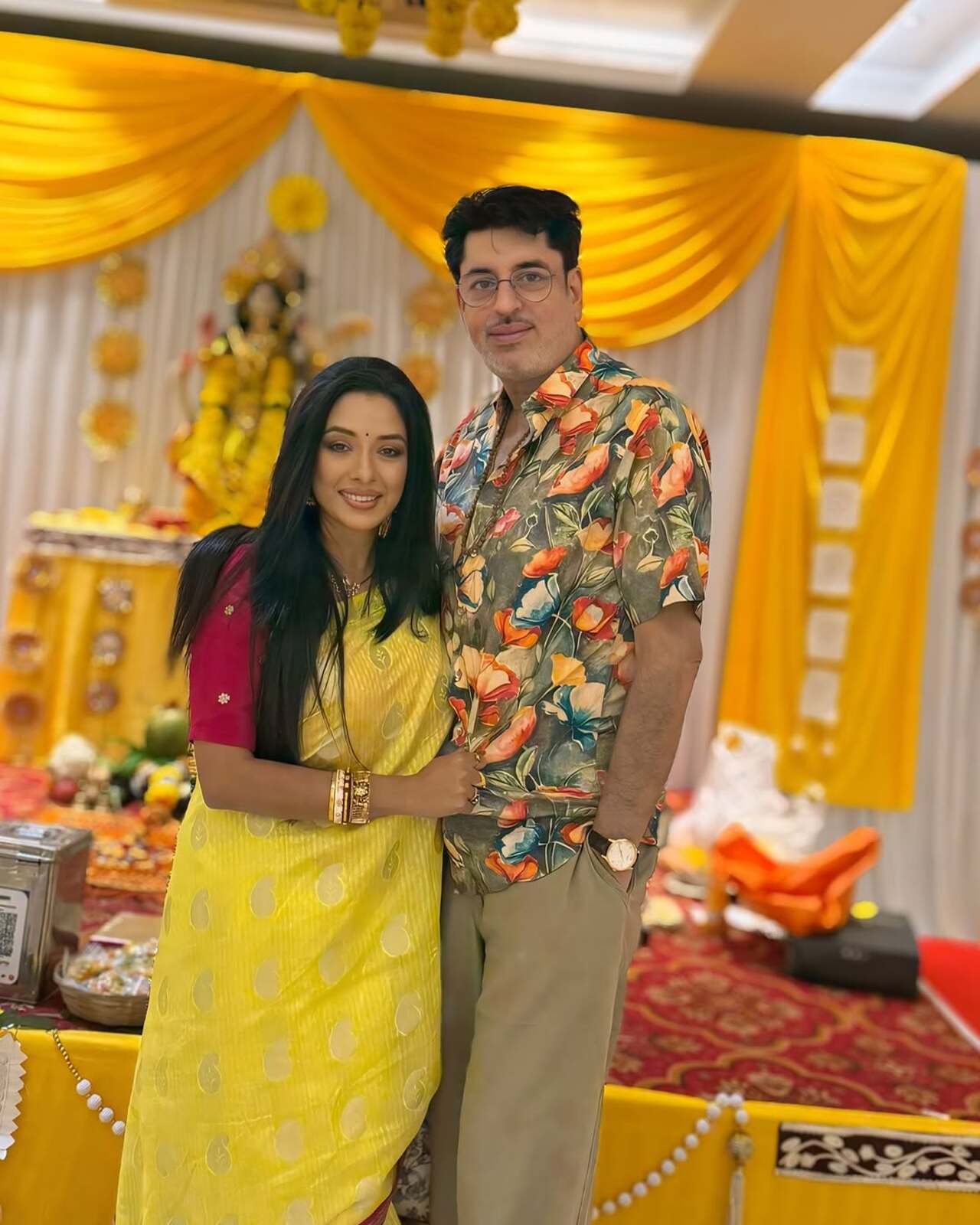 This picture has Ashwin and Rupali looking smart in stylish outfits as they pose together