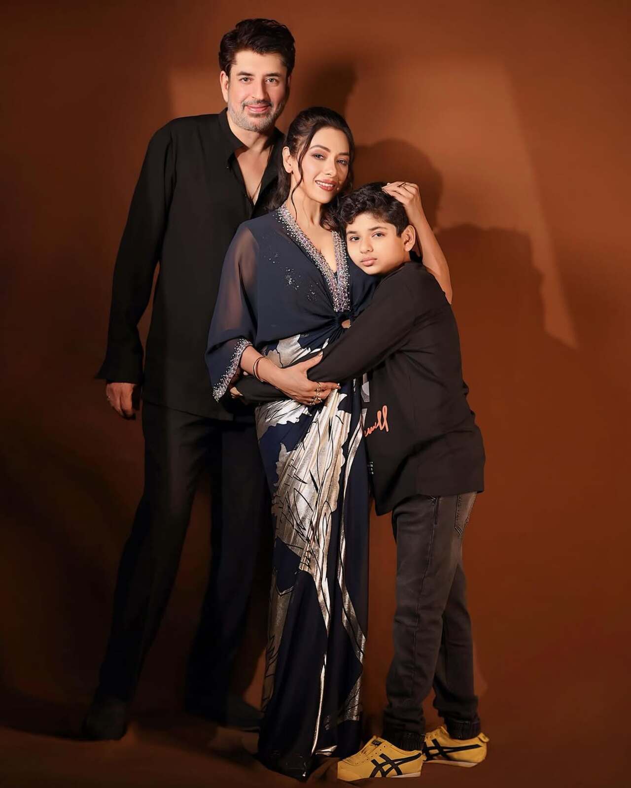 The first picture has Rupali Ganguly posing with Ashwin K. Verma and her little son Rudr