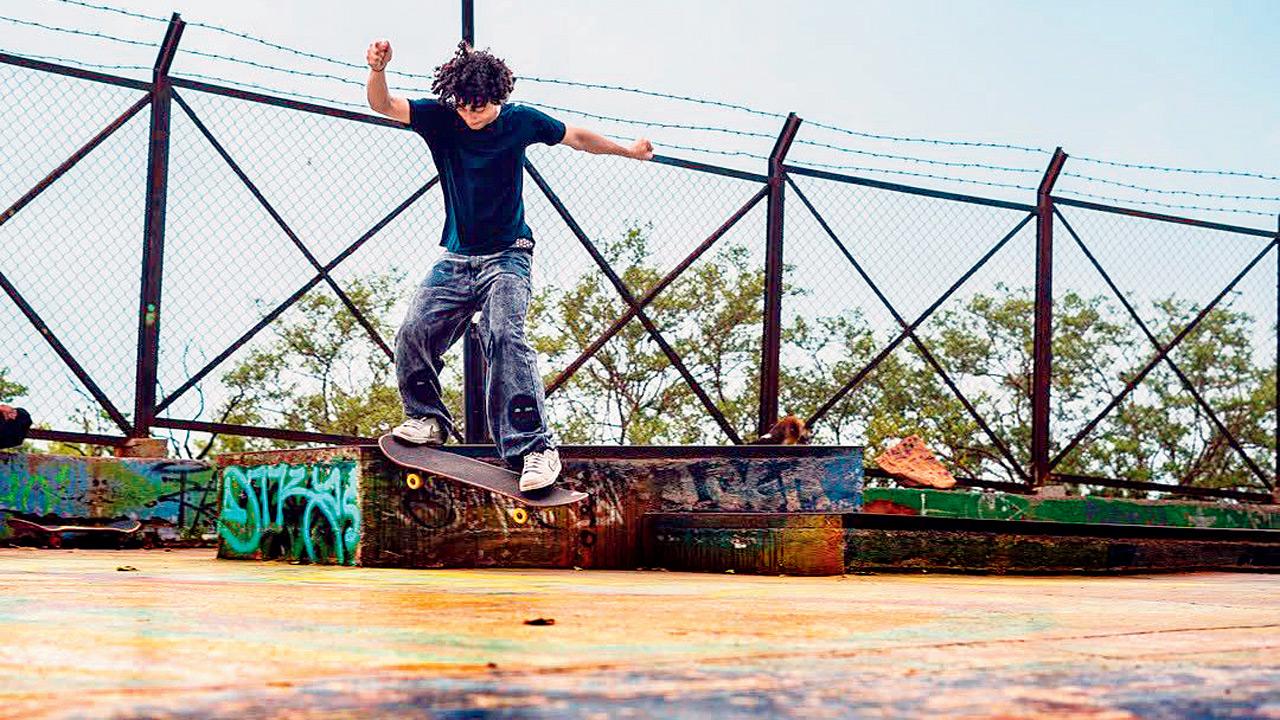 A skateboarder from the community shows off his tricks