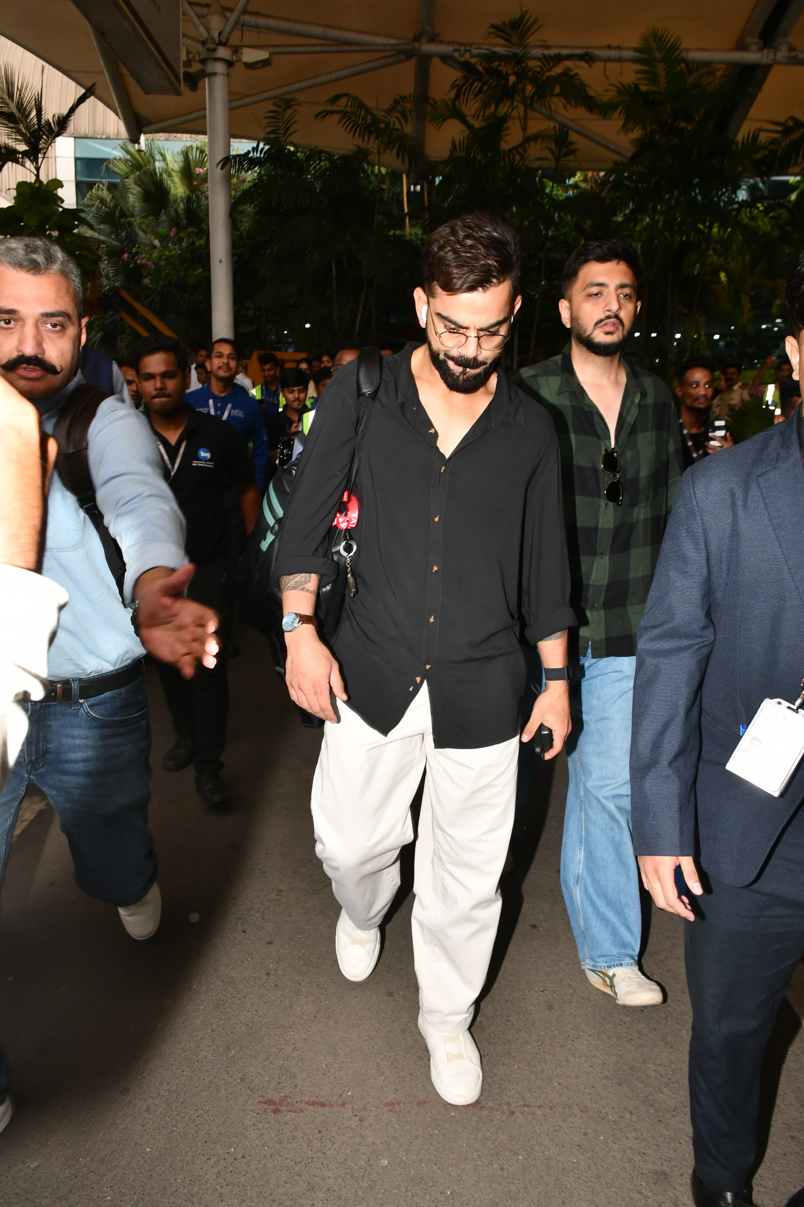 Virat Kohli looked smart in a casual black shirt and loose pants as he was snapped at Mumbai airport
