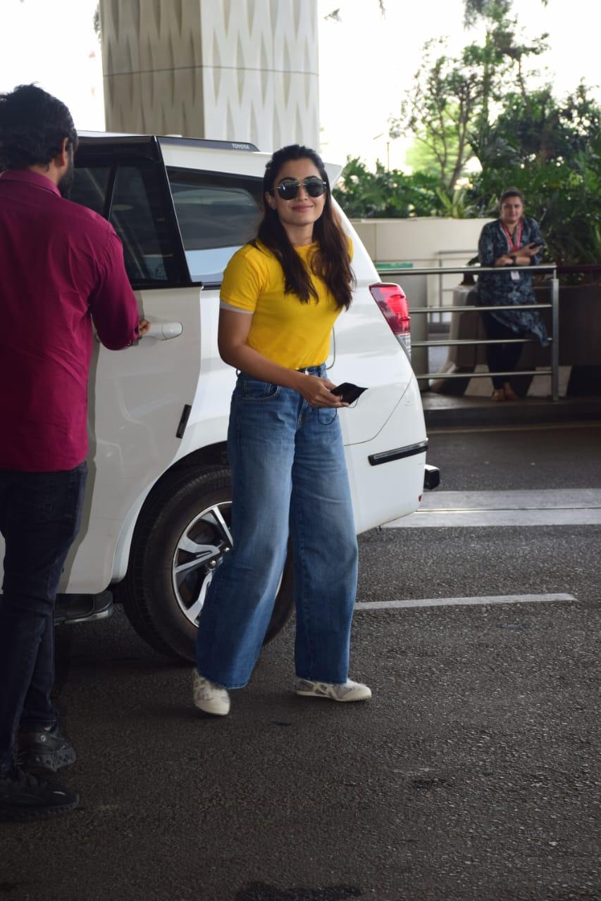 Rashmika Mandanna’s airport look is sure to inspire. Today, the actress was snapped at the airport wearing a comfy yellow T-shirt paired with loose pants