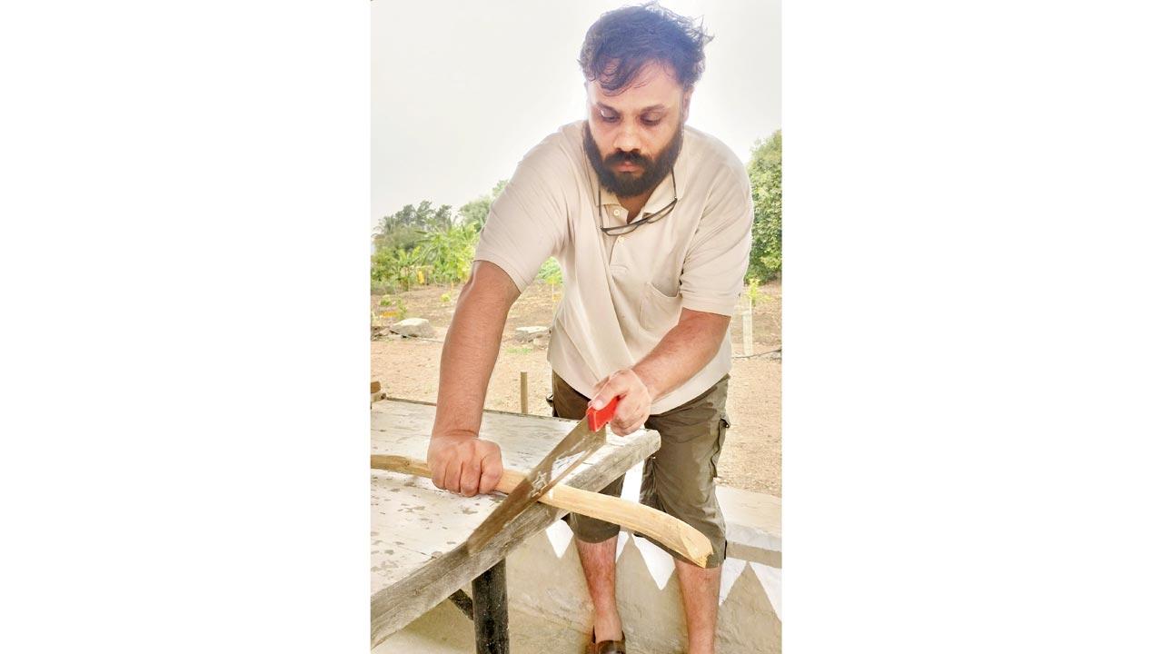 Parth Satam, tries to use the handsaw on a stick of raw teakwood