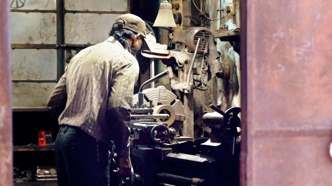 A man works on a machine in a factory in the locality