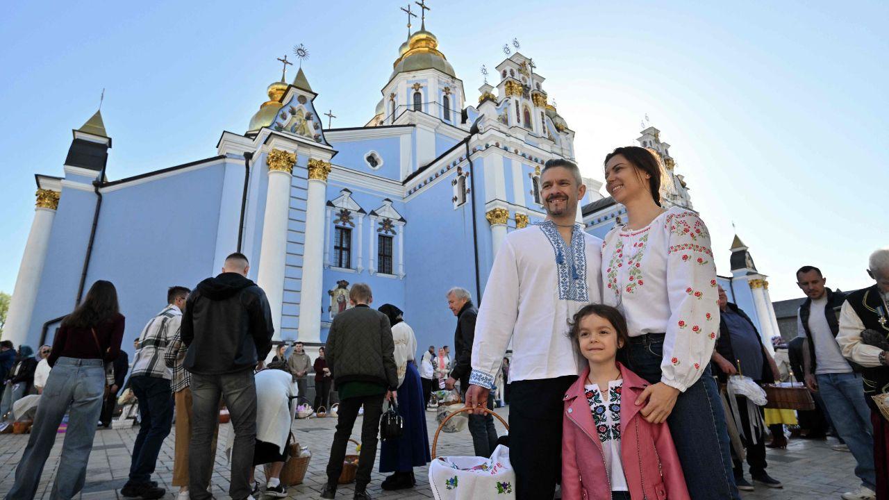 A family poses for picture after the Easter service in Saint Michael's Golden-domed Cathedral in Kyiv