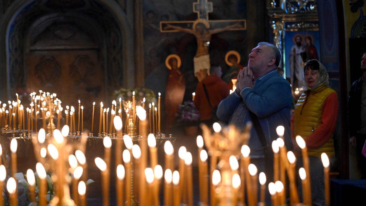 Devotees light candles at Saint Michael's Golden-Domed Cathedral 