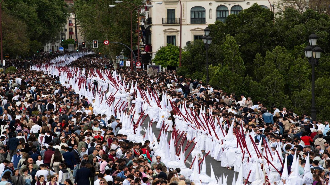 The Penitents, also called the 'nazarenos' clad in pointed hoods and robes, carry forward the essence of Seville’s timeless catholic rituals.