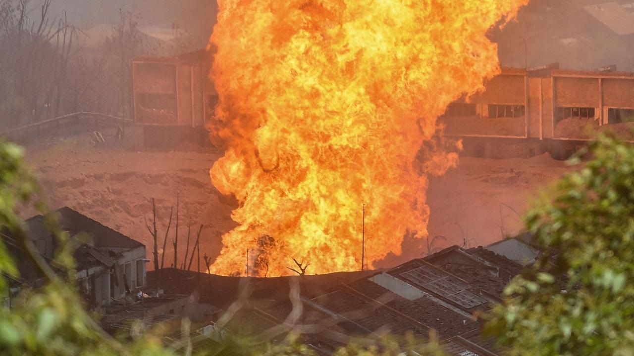 A massive fire forced people from their homes as it towered over residential districts on Tuesday. Pics and Text/AFP