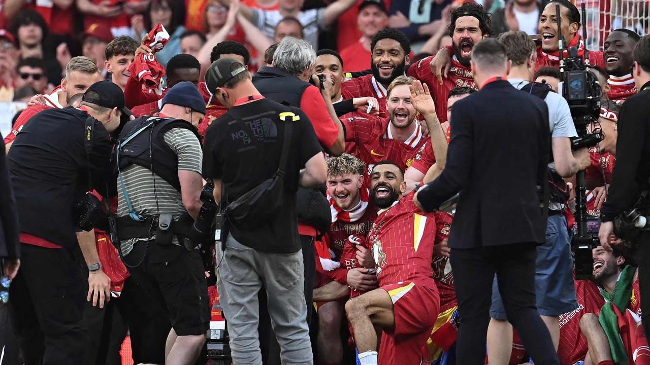 Liverpool`s English midfielder Harvey Elliott, Liverpool`s Egyptian striker Mohamed Salah, Liverpool`s English defender Trent Alexander-Arnold, Liverpool`s English defender Joe Gomez, Liverpool`s Brazilian goalkeeper Alisson Becker, Liverpool`s Japanese midfielder Wataru Endo pose with teammates after winning the English Premier League football match between Liverpool and Tottenham Hotspur at Anfield in Liverpool, north west England. Pic/AFP