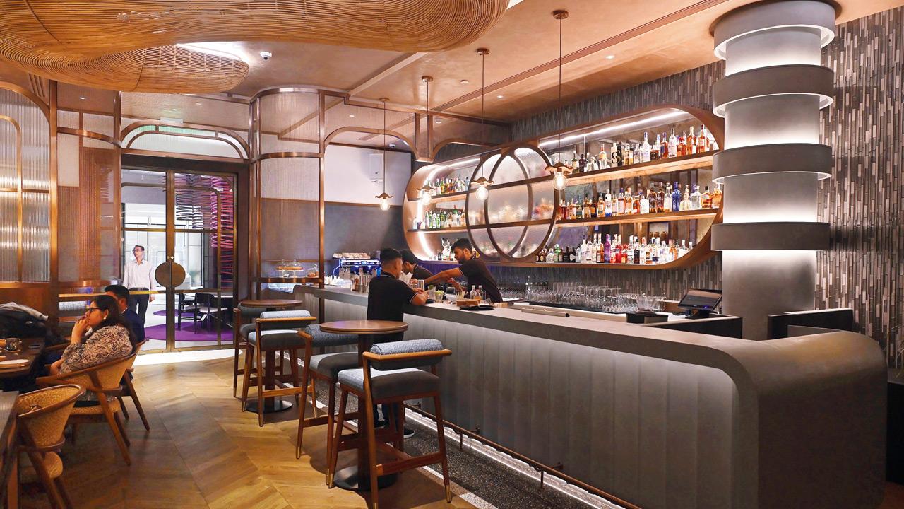 The space radiates warmth with rich wood tones, gentle lighting, and artful sculptural details