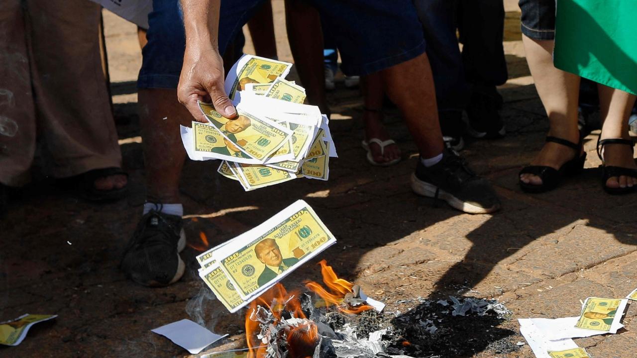 The protesters burnt US flags and papers imitating US dollar bills during a demonstration in defense of national sovereignty following trade tariffs and sanctions imposed by the US government on Brazil