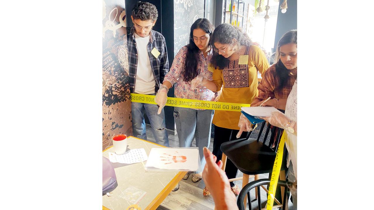 Participants examine the scene at Nishar’s forensic psychology pop-up. PICS COURTESY/KRUPA NISHAR