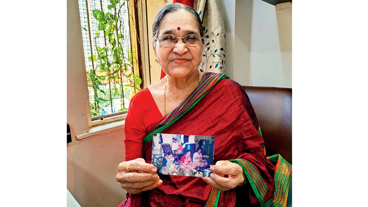 Beneficiary Smita Shetye shows a photo of her old BDD house. PIC/RITIKA GONDHALEKAR