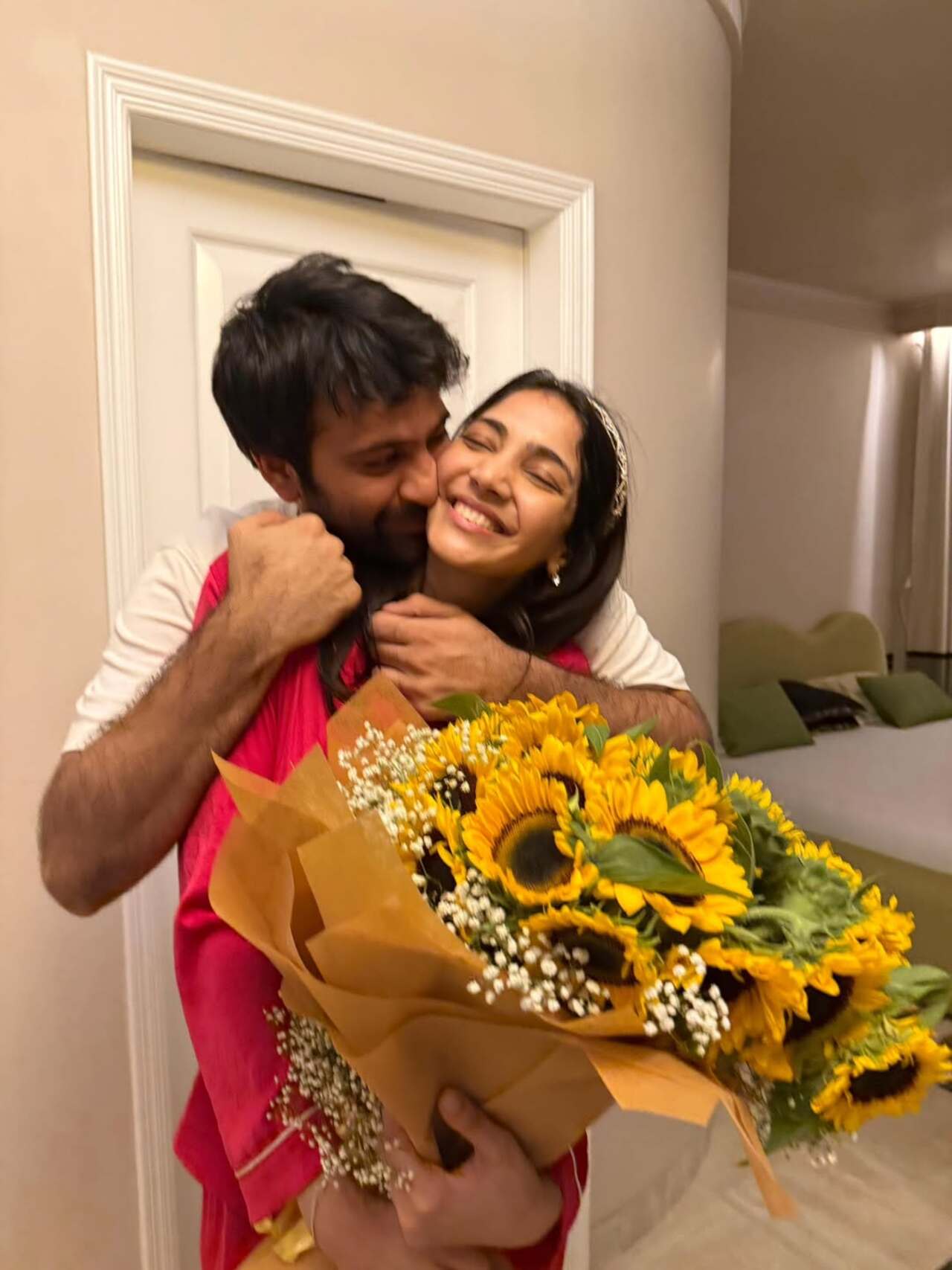Soon after their engagement, the two clicked for some pictures where she held the huge bouquet of sunflowers, while he kissed her on the cheek from behind. 