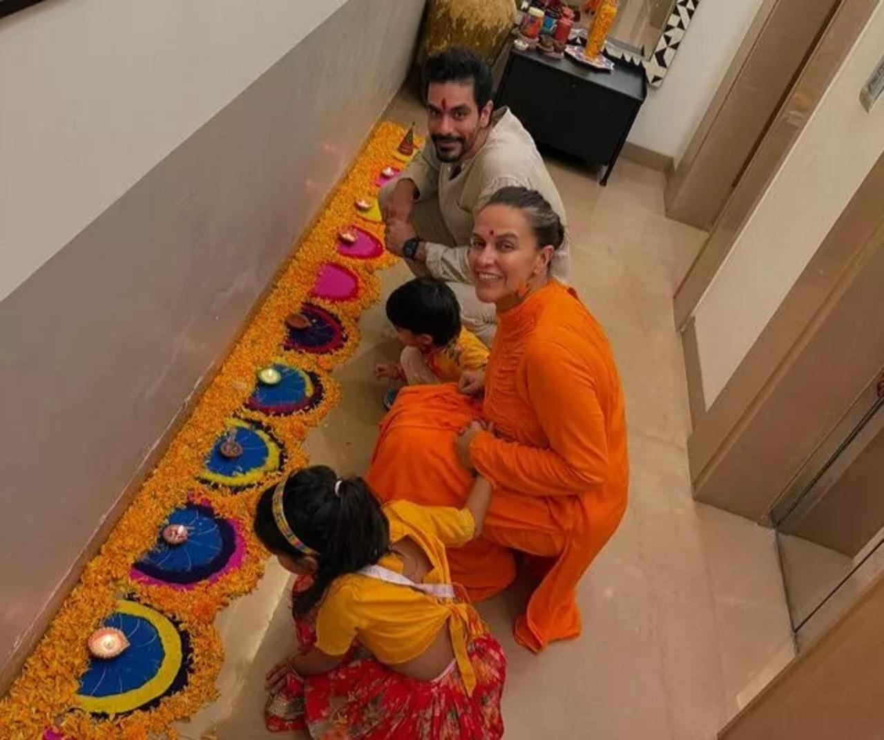 This picture from their Diwali celebrations is too adorable as the two little munchkins cannot take their eyes off the beautiful rangoli.
