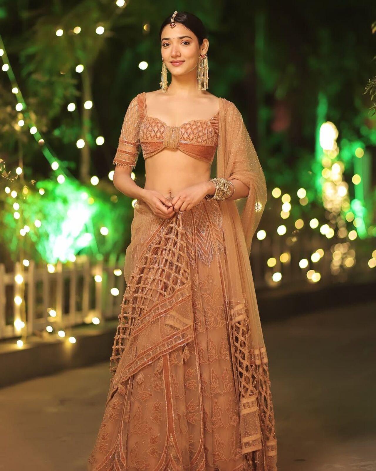 Looking gorgeous in a lehenga, Medha adds a contemporary touch with the uniquely designed blouse. The fish net like design on the dupatta adds visual variations to this look.