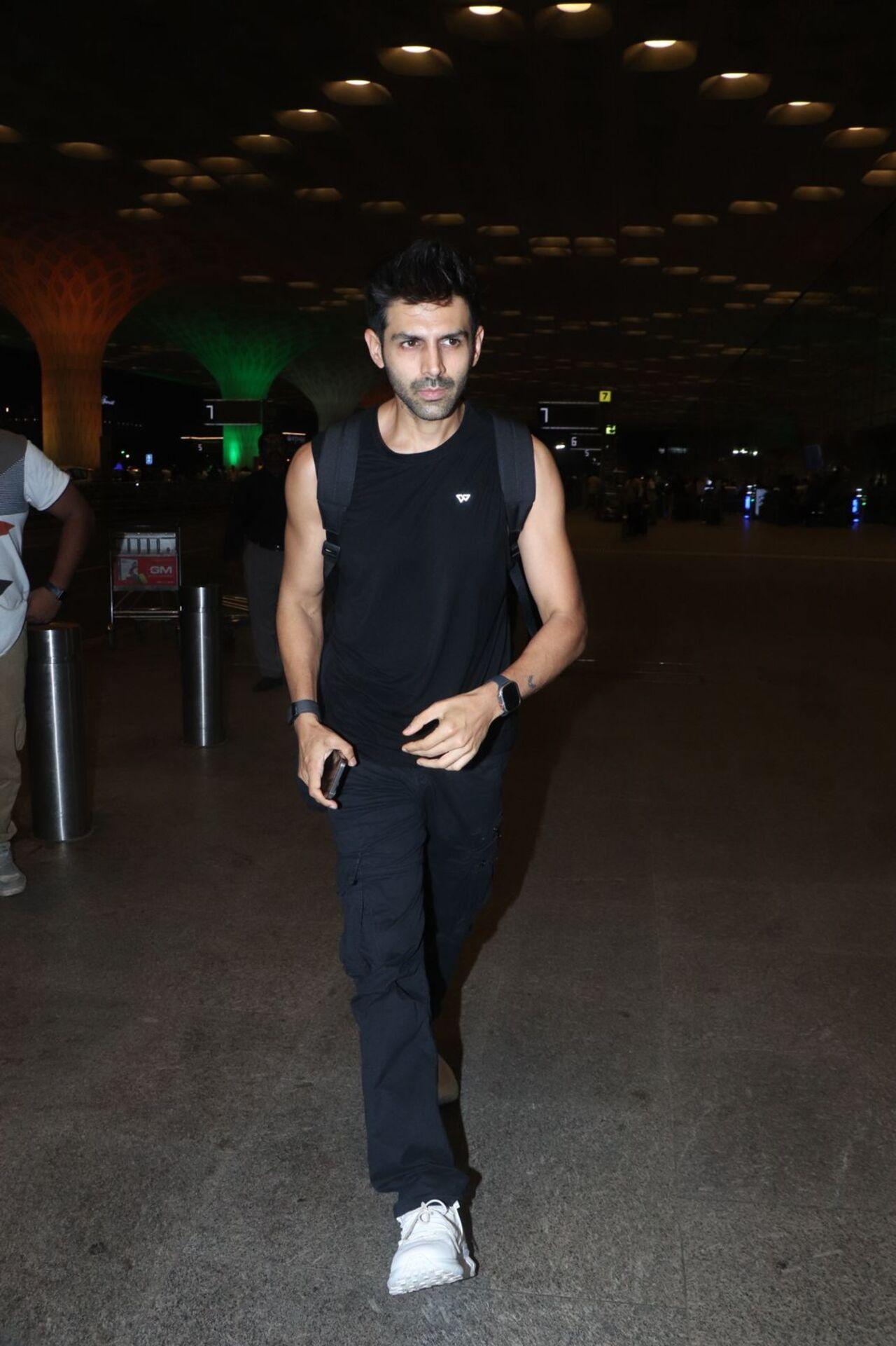 Kartik's new look? The actor goes for a new cut and semi-shaved look as he rushes to catch a flight