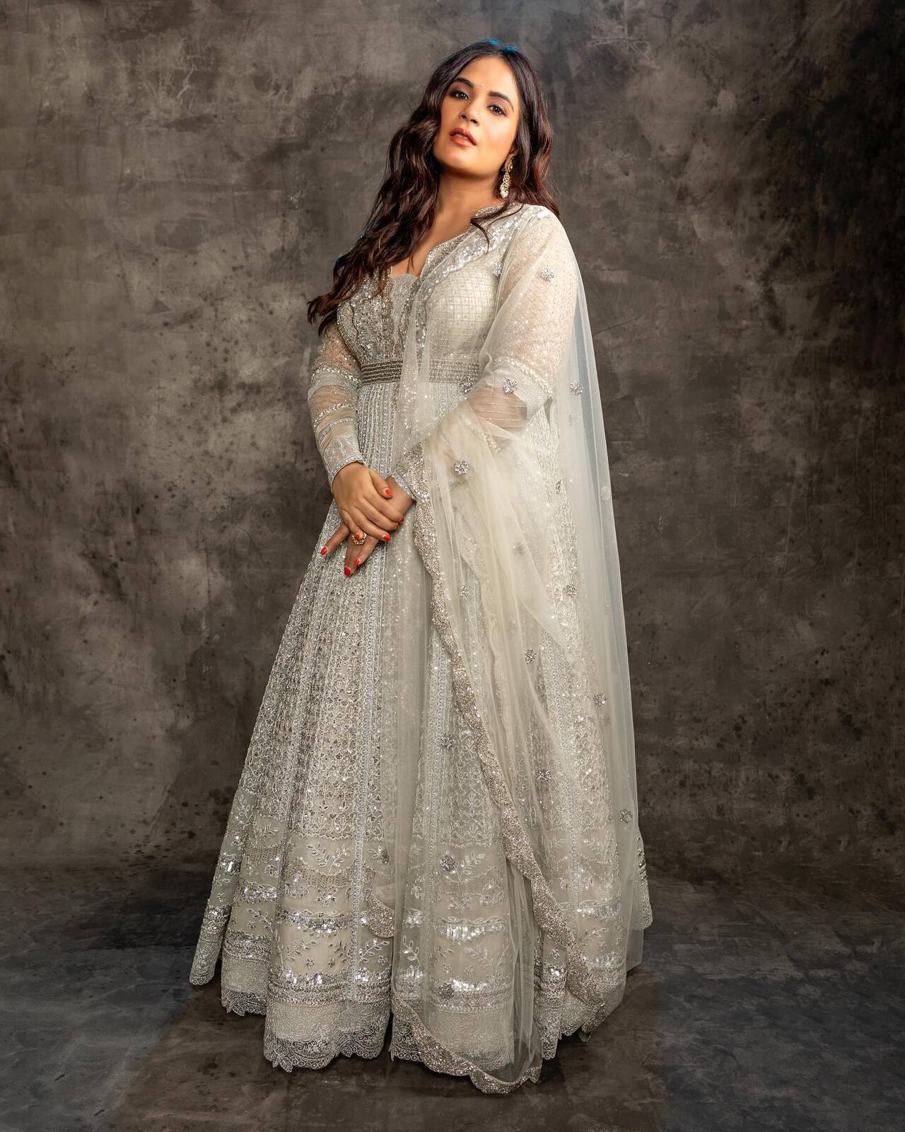 Richa Chadha glows in an ivory ensemble, where intricate embroidery meets effortless grace. Soft textures, delicate detailing, and a timeless silhouette make this look pure elegance.