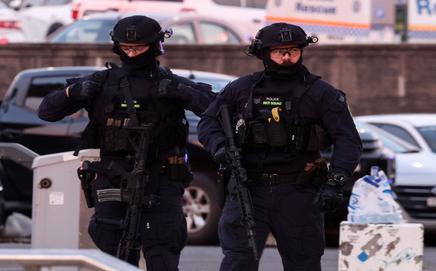 Armed police work at the scene after a shooting incident at Bondi Beach in Sydney on Sunday. PIC/AFP