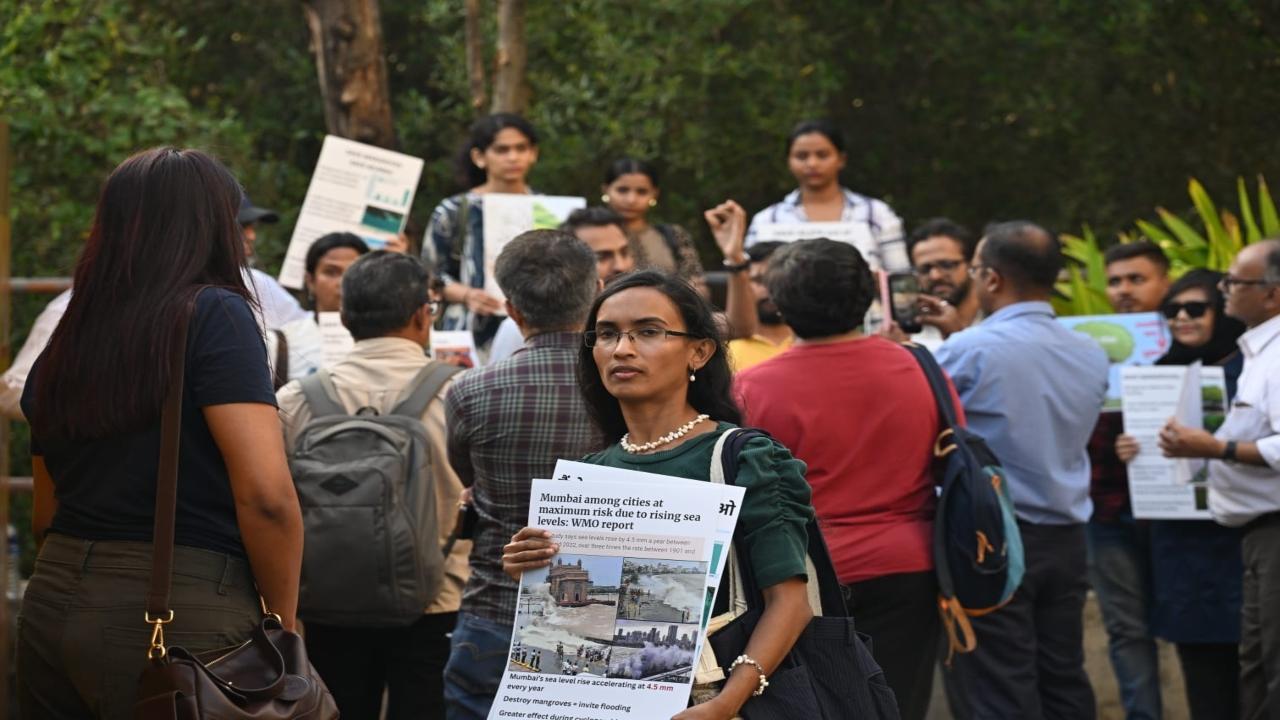 The protest follows the Bombay High Court’s approval for mangrove felling with conditions on compensatory plantation