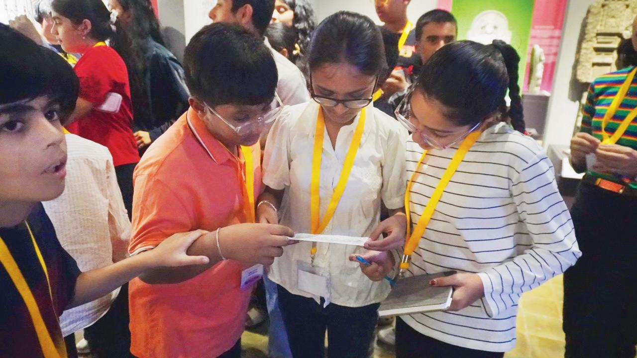 The young curators pore over a title card. Pic Courtesy/CSMVS