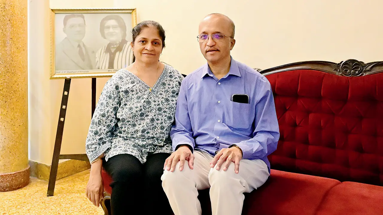 Dr Ashwin Correa and his wife Dr Samantha Correa in Ascension House, with a portrait of his grandparents, Professor Raphael d’Almeida and Elfreda d’Almeida
