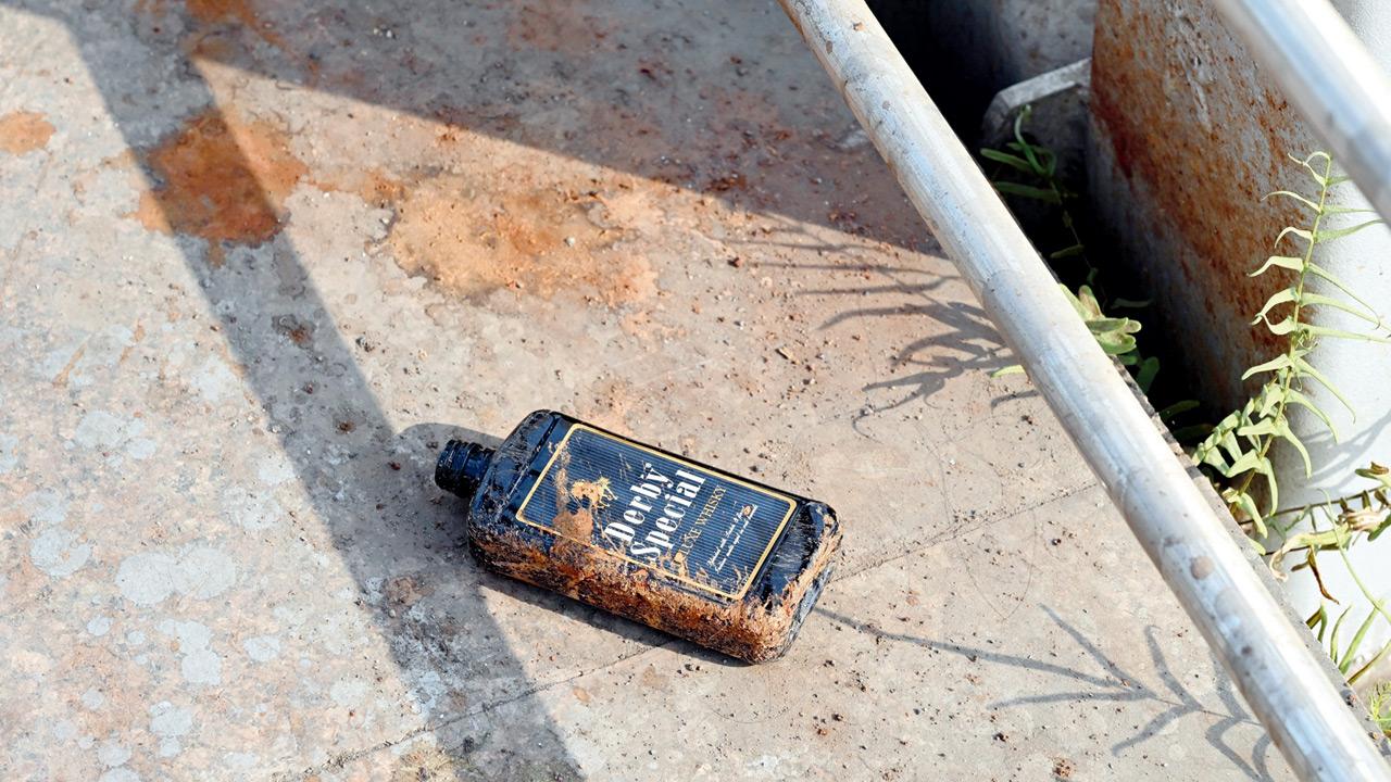 One of several alcohol bottles seen lying on the bridge