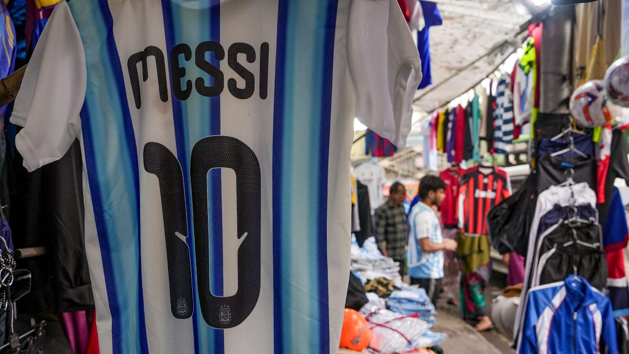 A vendor sells Argentine footballer Lionel Messi`s jerseys ahead of his visit to the city as part of the `G.O.A.T. India Tour 2025`, in Kolkata on December 13 A vendor sells Argentine footballer Lionel Messi`s jerseys ahead of his visit to the city as part of the `G.O.A.T. India Tour 2025`, in Kolkata on December 13