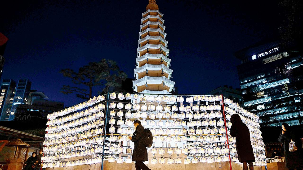 Visitors pray in front of lanterns attached with New Year’s wishes of Buddhist followers at Jogyesa Temple in central Seoul on Wednesday. PIC/AFP